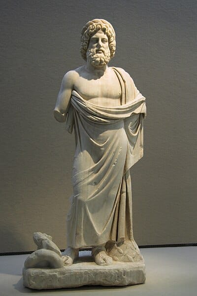 Ancient statue of Asclepius where you can clearly see the beginning of his rod with a snake around having been broken off.