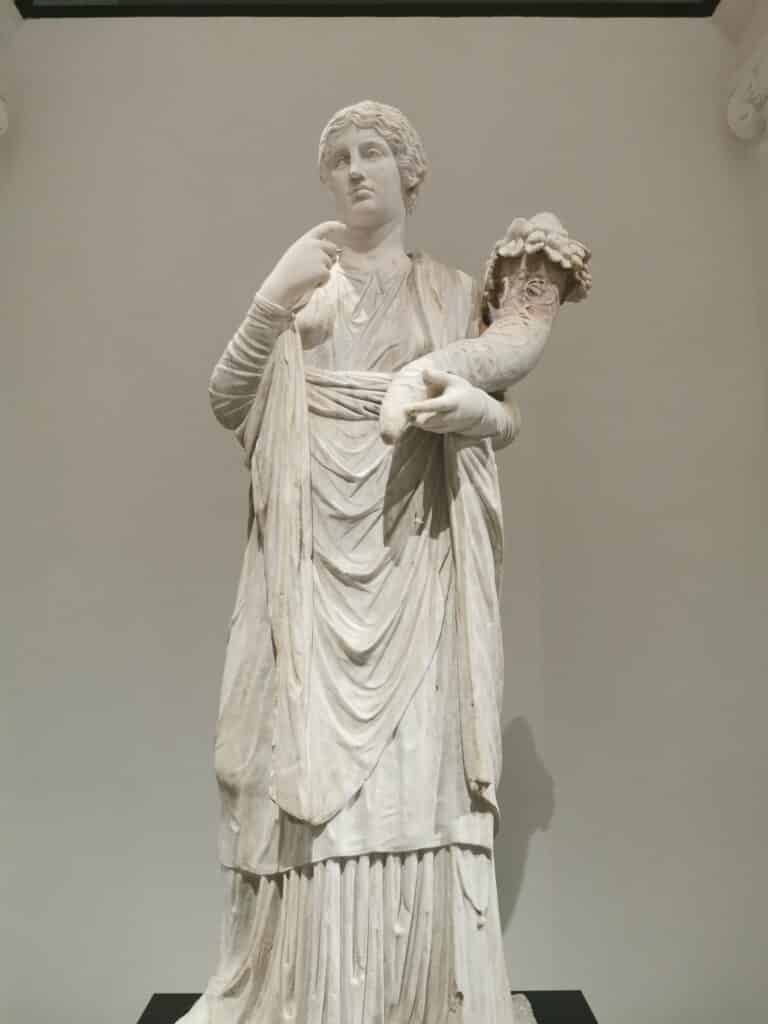 A draped female statue representing the deity Concordia, modeled after a Greek prototype from the 4th-3rd century BC. She holds a cornucopia, symbolizing prosperity. Pompeii, Building called of Eumachia, First half 1st century AD.