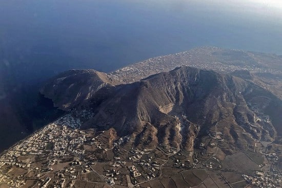 Aerial view of the island of Santorini with detail of Profitis Ilias (Santorini) and the ruins of ancient Thera (on the promontory on the left)
