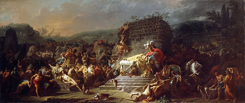 A grand and detailed painting depicting the funeral of Patroclus, a scene from Greek mythology. In the center, a somber figure, likely Achilles, mourns over the body of Patroclus, which is draped in a white cloth and laid out on a raised platform. Surrounding the central scene are numerous figures, animals, and chariots, all engaged in the elaborate funeral rites, which include sacrifices and offerings. The background features a large pyre, ready to be lit for the cremation, and ships in the distance, hinting at the broader context of the Trojan War.